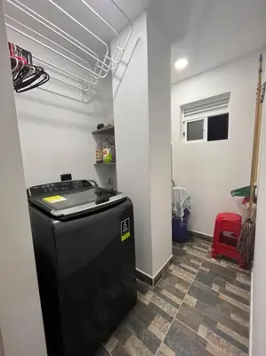 a kitchen with a black refrigerator in a room at Lindo apartamento en Guatapé in Guatapé