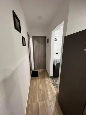a hallway with white walls and a wooden floor at Lindo apartamento en Guatapé in Guatapé