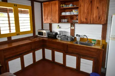 a kitchen with wooden cabinets and a sink at Marina Navegar in Guatapé