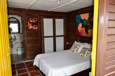 a small bedroom with a bed in a room at Marina Navegar in Guatapé