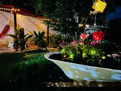 a garden with a white planter with flowers in it at Magic Jardín Hostel - Patio, Balcony & Rooftop in Jardin