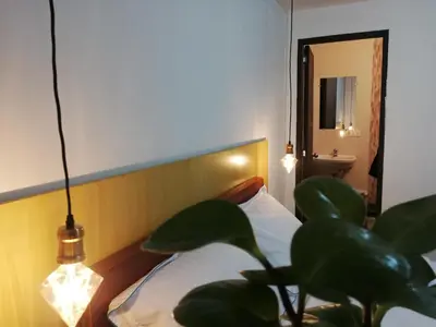 a bedroom with a bed and a potted plant at Magic Jardín Hostel - Patio, Balcony & Rooftop in Jardin