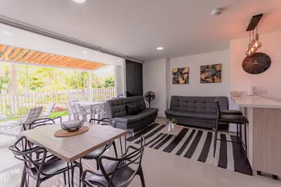 a living room with a table and chairs and a couch at Apartasol Dominica Citadela Di Sole in Santa Fe de Antioquia