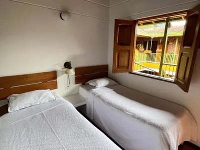 two beds in a room with a window at HOTEL MONTE VERDE in Concordia