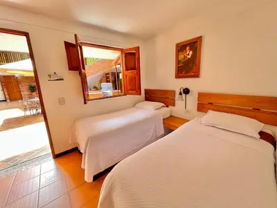 a hotel room with two beds and a window at HOTEL MONTE VERDE in Concordia