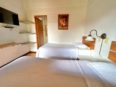 a hotel room with two beds and a television at HOTEL MONTE VERDE in Concordia