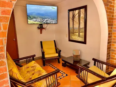 a living room with a couch and a chair at HOTEL MONTE VERDE in Concordia