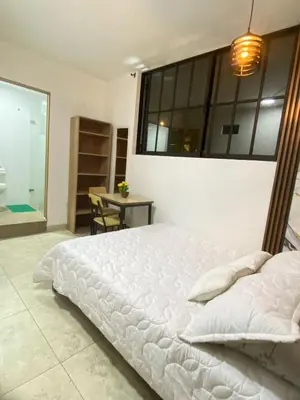 a bedroom with a large white bed and a window at 23 BELO APARTAMENTO CON BALCON EN LAURELES ESTADiO 2 HAB 2 BAÑOs in Medellín