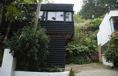 a black house with a window on the side of it at The TREE house in Envigado