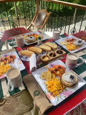 a table with many different types of food on it at Hotel La Sultana in Jardin