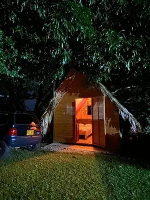 a small shack with a car parked in front of it at Finca Alto Bonito in Doradal