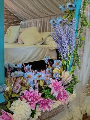 a bunch of flowers sitting on top of a bed at Finca Alto Bonito in Doradal