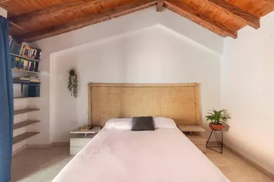 a bedroom with a large white bed in a room at Letto Hostal in Rionegro