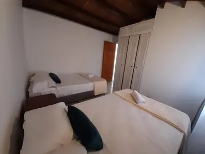 a small room with two beds and a closet at Road Living Home in Medellín