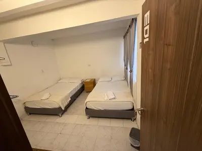 two beds in a room with a door open at Road Living Home in Medellín