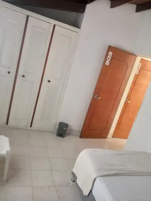 a room with three doors and a room with at Road Living Home in Medellín