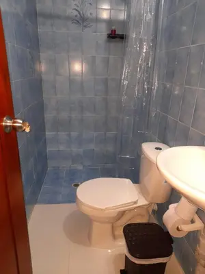 a bathroom with a toilet and a sink and a shower at Road Living Home in Medellín