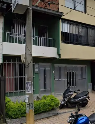 a scooter parked in front of a building at Road Living Home in Medellín