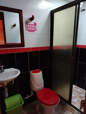 a bathroom with a toilet and a sink and a shower at Casa Hotel Los Faroles- Samaná/Caldas in Samaná