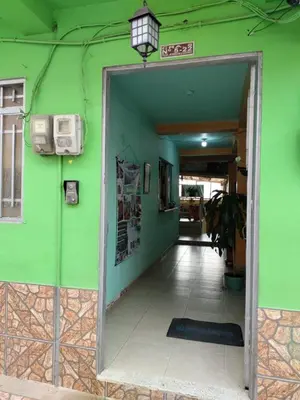 a green wall with a doorway into a hallway at Casa Hotel Los Faroles- Samaná/Caldas in Samaná
