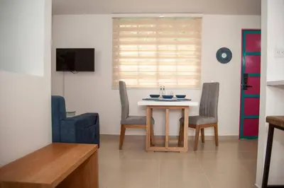 a living room with a table and two chairs at Apartamento Duplex - Aqua Guatape in Guatapé