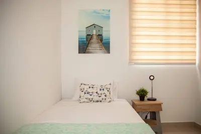 a bedroom with a bed and a picture of a pier at Apartamento Duplex - Aqua Guatape in Guatapé