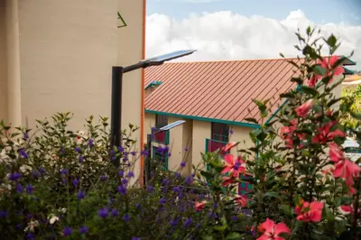 a house with a red roof and some flowers at Apartamento Duplex - Aqua Guatape in Guatapé