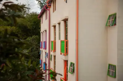 a building with colorful windows on the side of it at Apartamento Duplex - Aqua Guatape in Guatapé