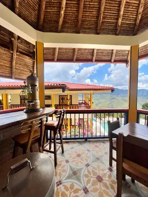 a room with a balcony with a view of the ocean at Hotel Terra Belén in Belén de Umbría
