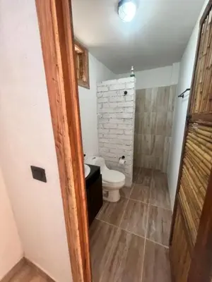 a bathroom with a toilet and a sink at Hotel Terra Belén in Belén de Umbría