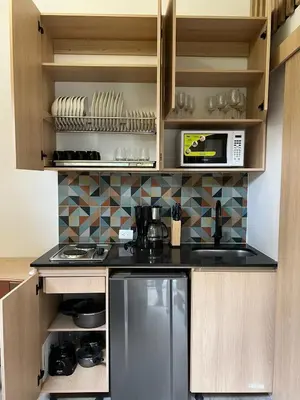 a kitchen with a stove and a refrigerator at Mini Casa en Poblado Medellín FRN109 By Roots Rentals in Medellín