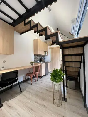 a kitchen and dining room with a staircase in a loft at Mini Casa en Poblado Medellín FRN109 By Roots Rentals in Medellín