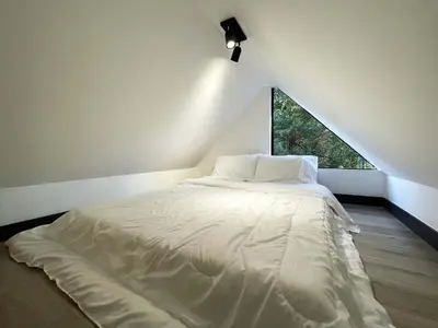 a white bed in a room with a window at Mini Casa en Poblado Medellín FRN109 By Roots Rentals in Medellín