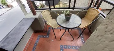 a table with two chairs and a potted plant on a balcony at Luxury Loft Shakespeare in Medellín