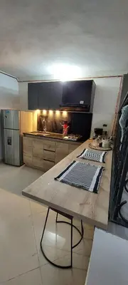 a kitchen with a wooden table in the middle at Luxury Loft Shakespeare in Medellín