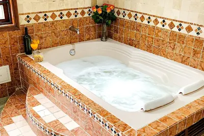 a bath tub filled with water in a bathroom at Luxury Villa In Provenza in Medellín