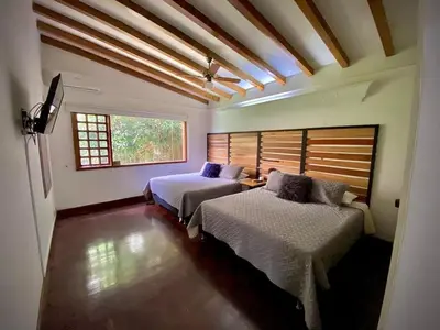 a bedroom with two beds and a window at Luxury Villa In Provenza in Medellín