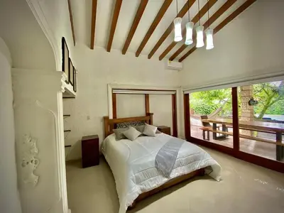 a bedroom with a bed and a large window at Luxury Villa In Provenza in Medellín