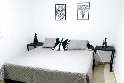 a bedroom with a bed and two side tables at Luxury Villa In Provenza in Medellín