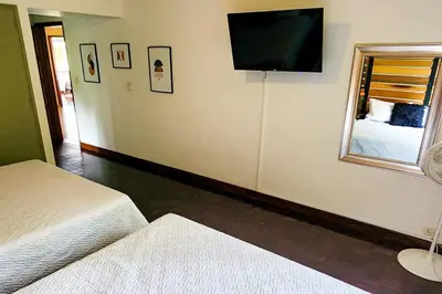 a bedroom with two beds and a flat screen tv at Luxury Villa In Provenza in Medellín