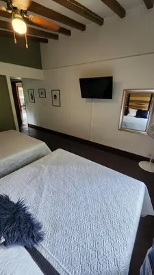a bedroom with two beds and a flat screen tv at Luxury Villa In Provenza in Medellín