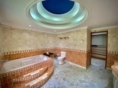 a large bathroom with a tub and a toilet at Luxury Villa In Provenza in Medellín