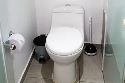 a bathroom with a white toilet in a stall at Casa Jiwa In Provenza in Medellín