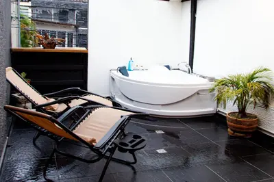 a bathroom with a tub sitting on a balcony at Casa Jiwa In Provenza in Medellín