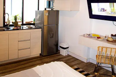 a kitchen with a stainless steel refrigerator and a counter at Casa Jiwa In Provenza in Medellín