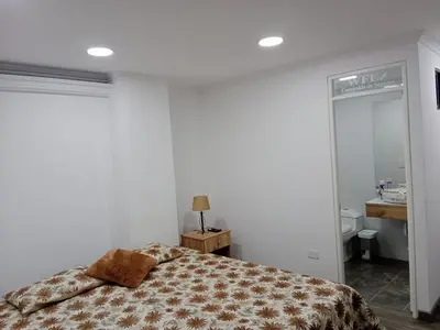 a bedroom with a bed and a bathroom at Medellin apartamento en laureles in Medellín