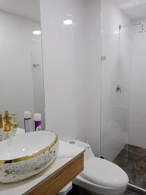a bathroom with a sink and a toilet and a shower at Medellin apartamento en laureles in Medellín