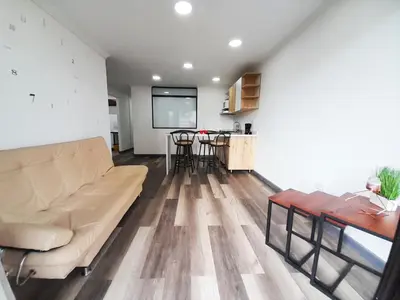 a living room with a couch and a table at Medellin apartamento en laureles in Medellín
