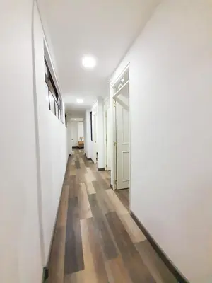 an empty hallway with white walls and wooden floors at Medellin apartamento en laureles in Medellín