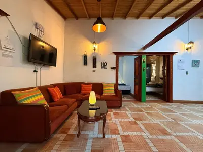 a living room with a couch and a table at Maravilla de cabaña grupal 5-10 personas parking, wifi, campestre, cercana in Jardin